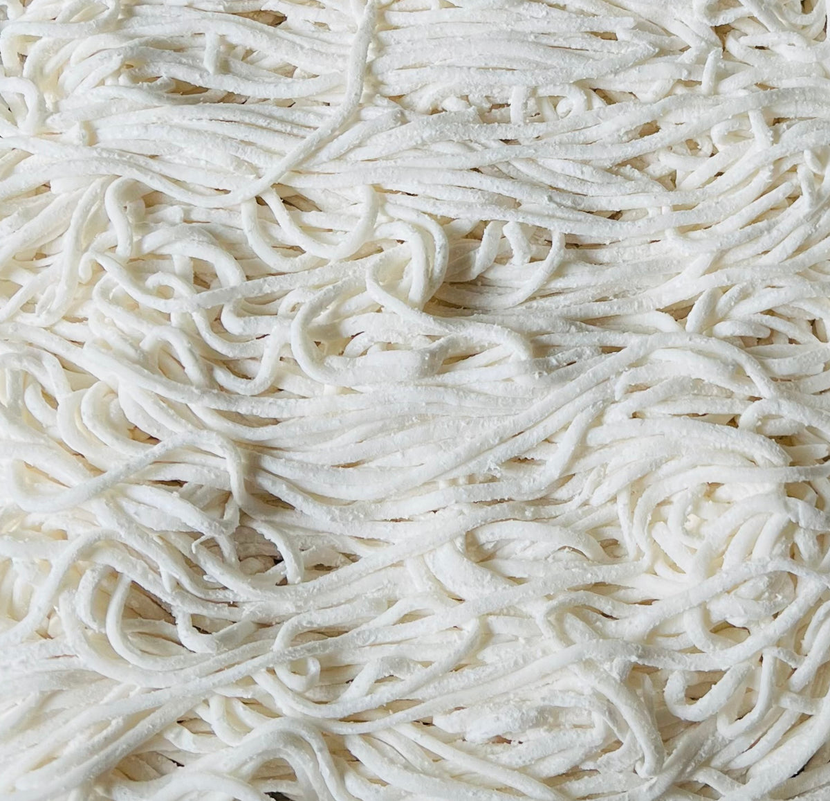 "White noodle strings".  Thin and long, white noodle strings are a popular type of pasta that are commonly used in Asian cuisine. They are made from wheat flour, water, and sometimes rice flour, and can be served in soups, stir-fries, or as a side dish. The texture of white noodle strings is soft and chewy, and they are often used as a substitute for rice in many dishes.