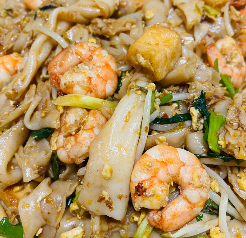 The delicious stir-fried fresh noodles are a flavor-packed dish with a delectable blend of onion, savory fish tofu, and spicy flakes that create a truly memorable dining experience.